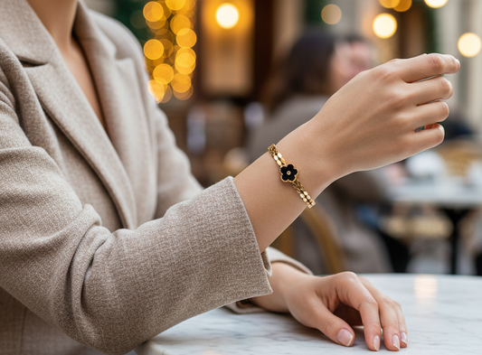 Person sitting at an outdoor cafe table with blurred background