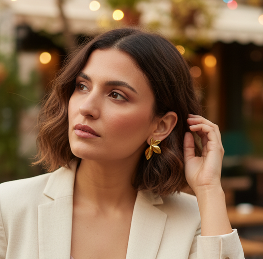 Woman adjusting her hair in an outdoor setting with blurred background