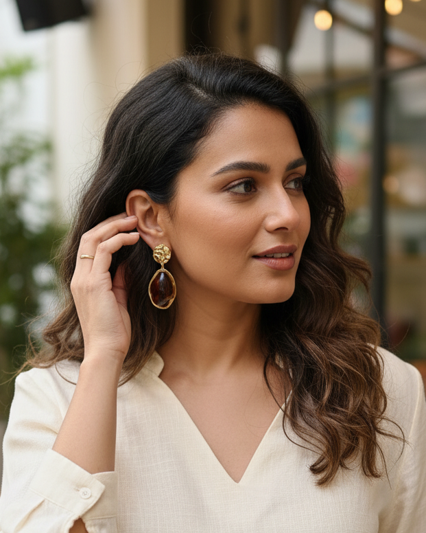 Artistic Profile Gold Drop Earrings with Amber-Tone Acrylic