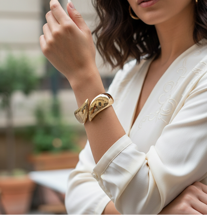 Woman wearing a gold bracelet in an outdoor setting