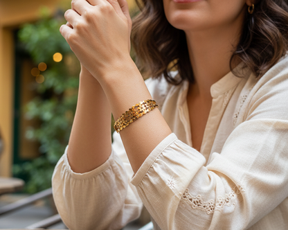 Woman in a beige blouse sitting outdoors with blurred background