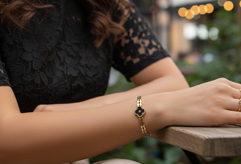 Person sitting at a wooden table with blurred outdoor background
