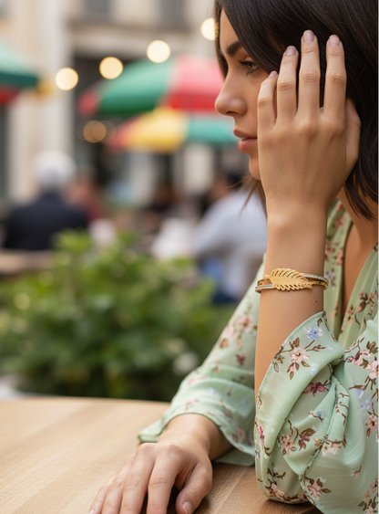 Woman sitting at an outdoor cafe table with a blurred background