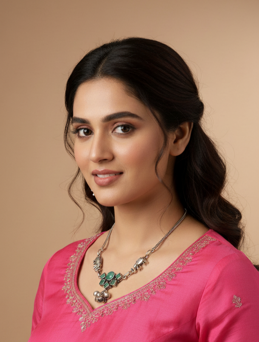Woman wearing a pink traditional outfit with jewelry against a beige background
