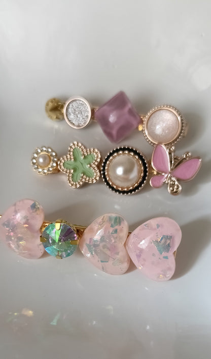 Set of decorative earrings with gemstones and pearls on a white background