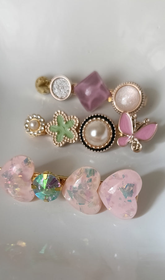 Set of decorative earrings with gemstones and pearls on a white background